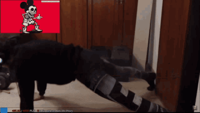a person is doing push ups in front of a mickey mouse cartoon