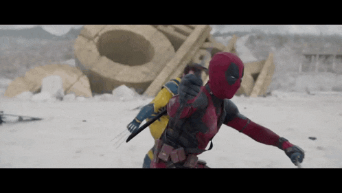 a man in a deadpool costume is standing in the snow