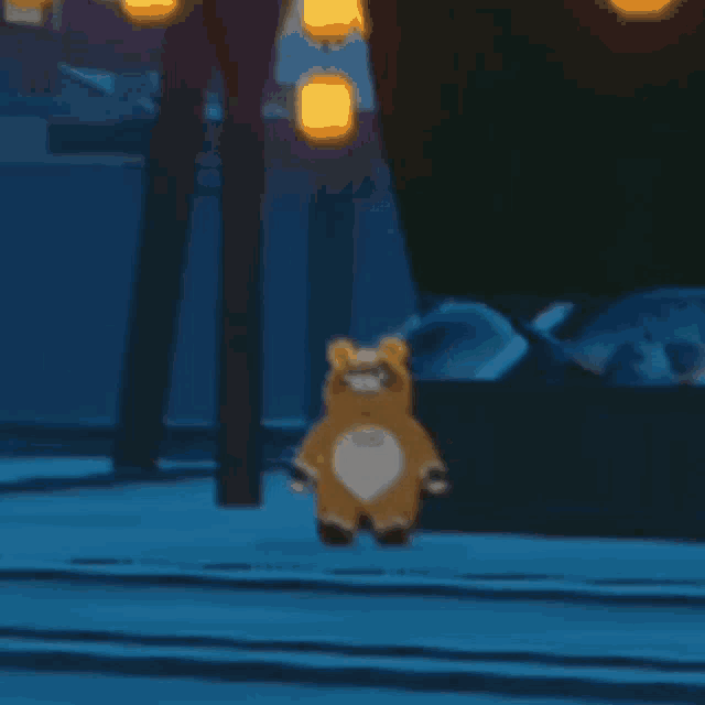a stuffed animal is hanging upside down from a pole in the snow .