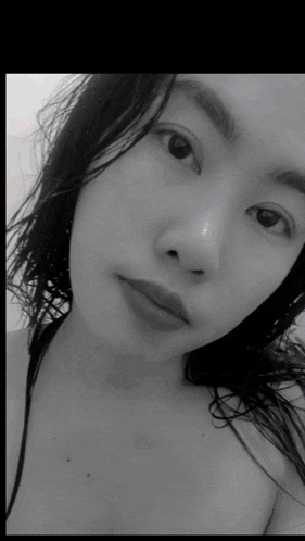 a black and white photo of a woman without a shirt on