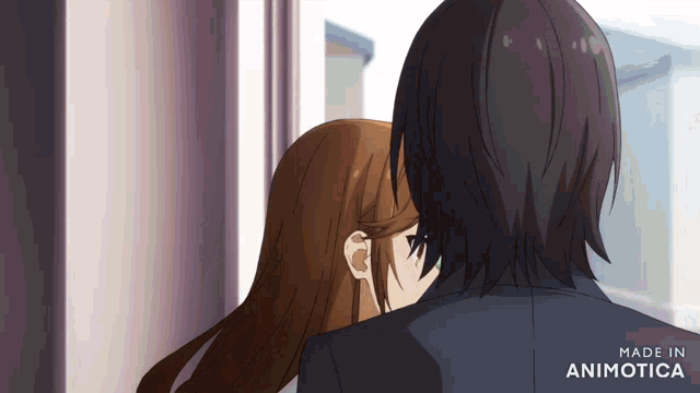 a couple of anime characters hugging with the words made in animotica on the bottom left