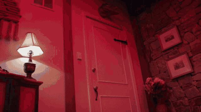 a man wearing a purple shirt that says i love you is standing in a doorway