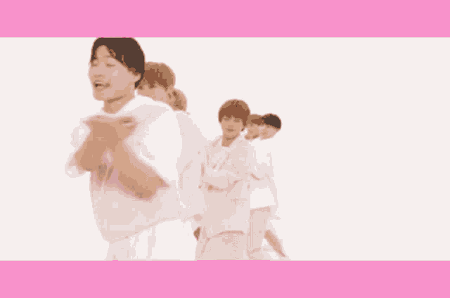 a group of people in pink and white outfits are dancing