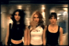 three women are standing next to each other in a room