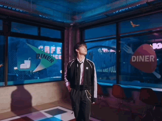 a man stands in a diner with a sign that says diner on it