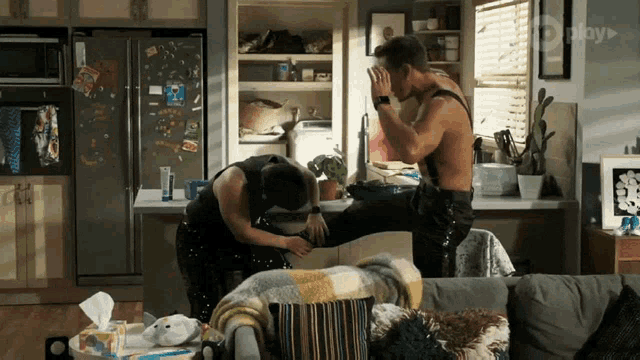 a man is kicking another man in the face in a living room