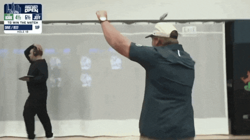 a man stands in front of a white board that says pro tour open