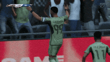 a soccer player wearing a number 99 jersey celebrates a goal