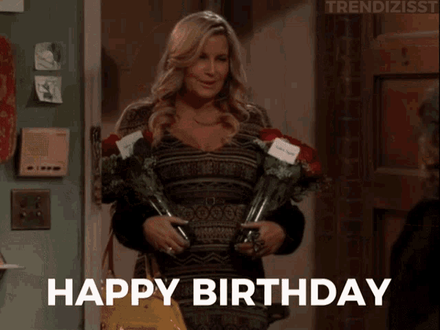 a woman is holding flowers in front of a door and the words happy birthday are above her