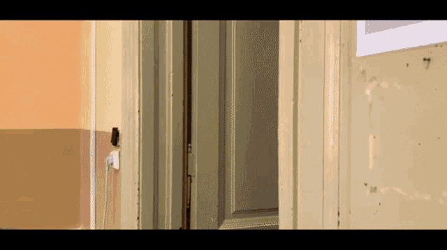 a door is open to a room with a sign on the wall that says 7