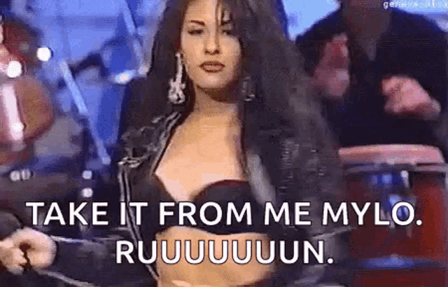 a woman is standing in front of a drum set and says `` take it from me mylo , ruuuuuuun . ''