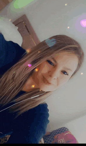 a woman with long blonde hair is taking a selfie in a bedroom