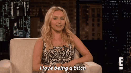 a blonde woman is sitting in a chair and saying i love being a bitch