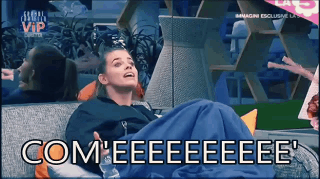 a woman is laying on a couch with the words com ' eeeeeee ' on the bottom right
