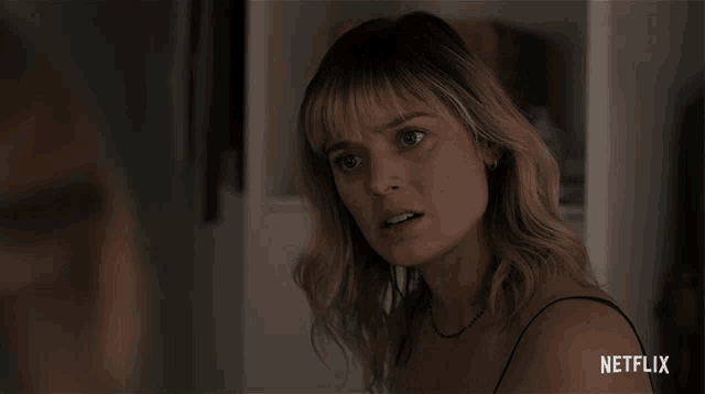 a close up of a woman 's face with a netflix logo on the bottom