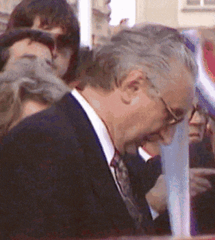 a man in a suit and tie is looking down