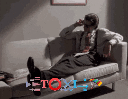 a man in a suit and tie is sitting on a couch with the word " toxic " on the bottom right