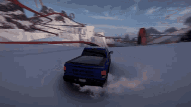 a blue ram truck is driving through a snowy area