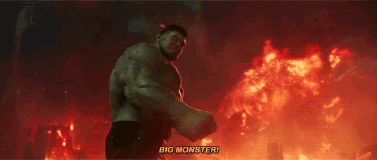 the hulk is standing in front of a fire and says " big monster "