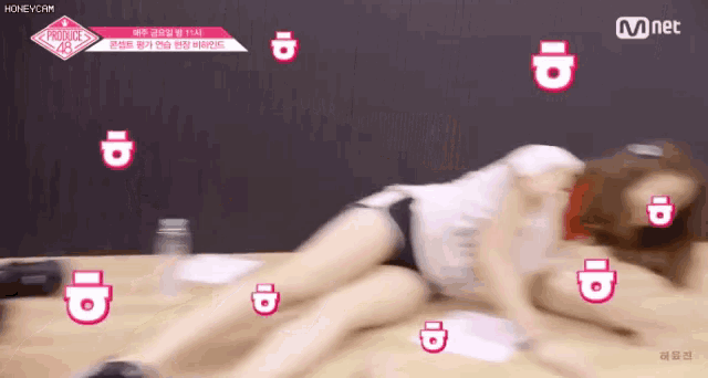 a woman is laying on the floor with a lot of id 's around her .
