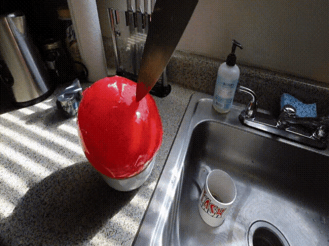 a white mug that says ash is in a sink