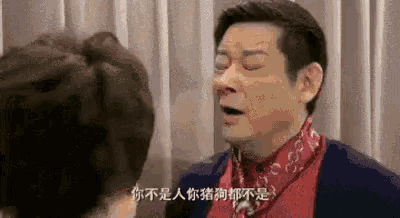 a man wearing a red scarf is talking to a woman in chinese .