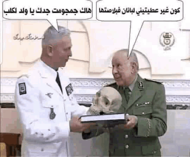 a man in a military uniform is holding a skull and talking to another man in a white suit .