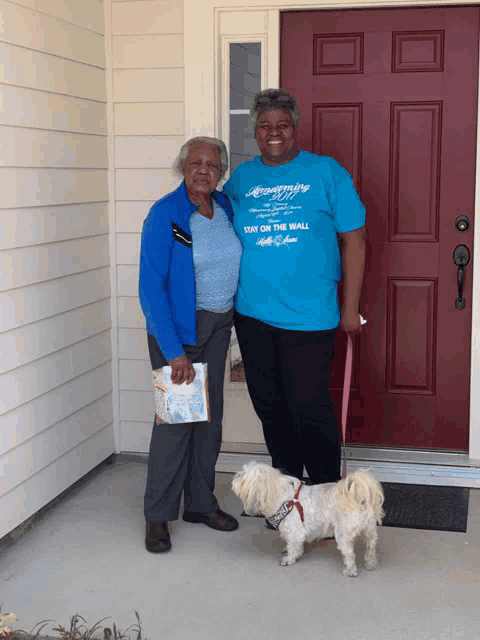 a woman in a blue shirt that says stay on the wall stands next to another woman