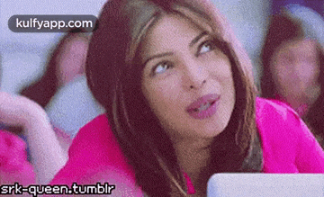 a woman is sitting in front of a laptop computer .