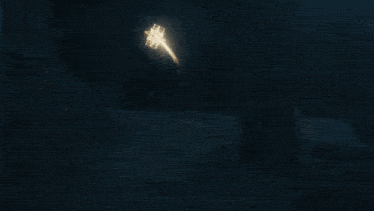 a man is sitting in front of a glowing object