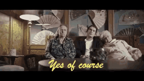 three elderly women are sitting on a couch and the words yes of course are on the screen