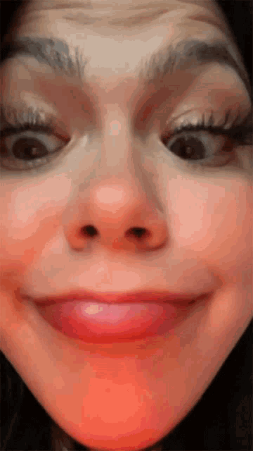 a close up of a woman 's face with a pink lip