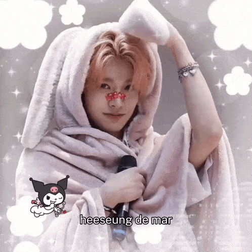 a person with a blanket on their head and the word heeseung on the bottom