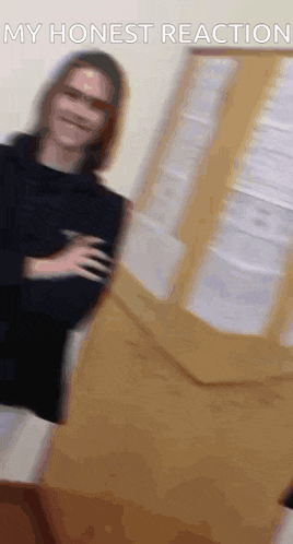 a blurry picture of a woman standing in front of a door with the words `` my honest reaction '' written above her .