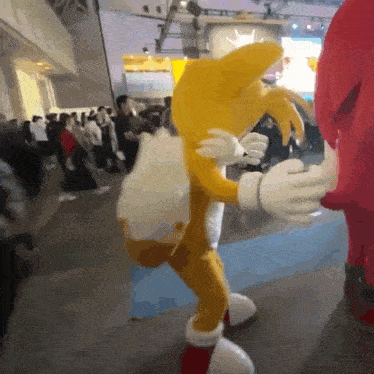 tails from sonic the hedgehog and knuckles from sonic the hedgehog are dancing together
