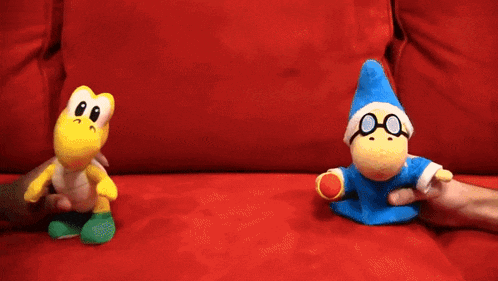 a person is holding a stuffed animal with a blue hat and glasses
