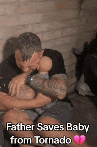 a man holding a baby with the words father saves baby from tornado