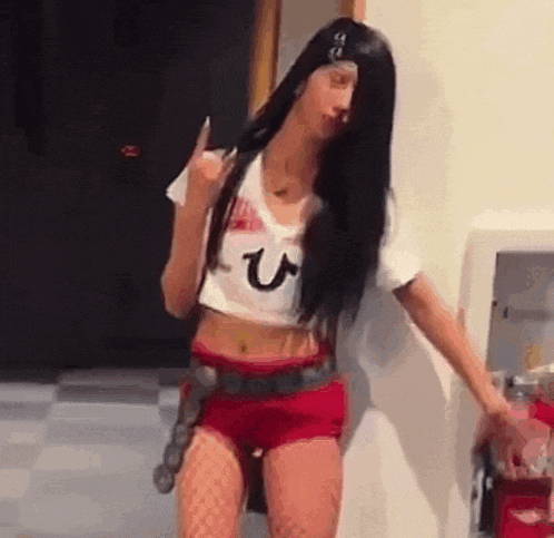 a woman in a pirate costume is standing in a room .