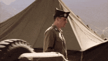 a man in a military uniform with a skull and crossbones on his hat