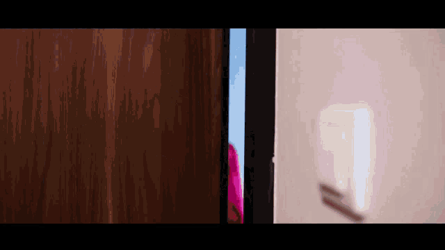 a blurred image of a light switch next to a door