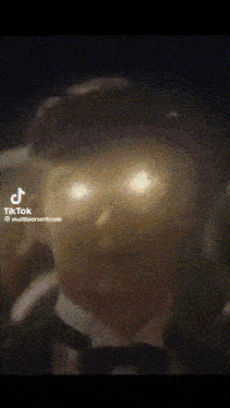 a close up of a person 's face with tik tok written on the bottom