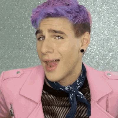 a young man with purple hair is wearing a pink jacket
