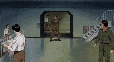 a group of men standing in a room with stairs and a man pointing