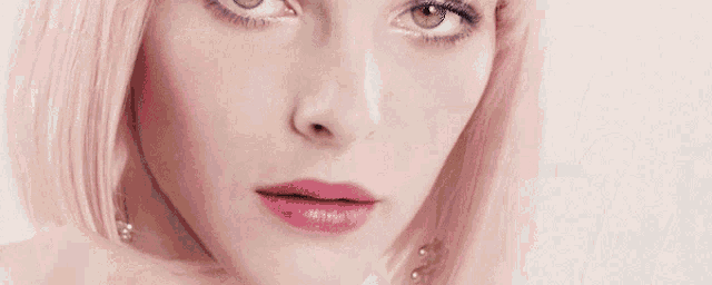 a close up of a woman 's face with pink lipstick on