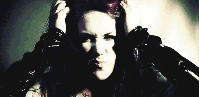 a woman with purple hair and a piercing in her mouth