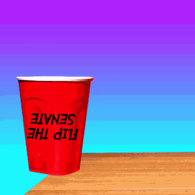 a red cup that says flip the senate sits on a table
