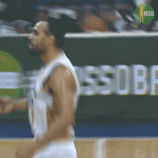 a blurry picture of a basketball player with a nbb logo in the background