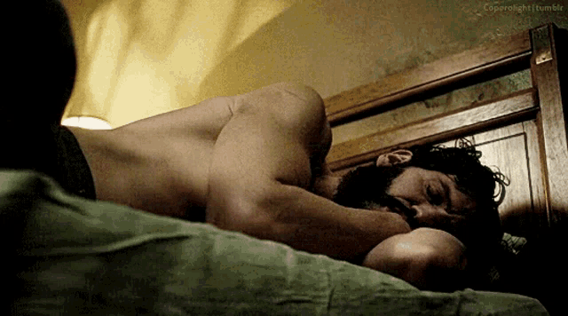 a man with a beard is sleeping on a bed with the words copyright tumblr visible