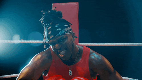a man wearing boxing gloves and a bandana has a necklace with a dog tag that says ' army '