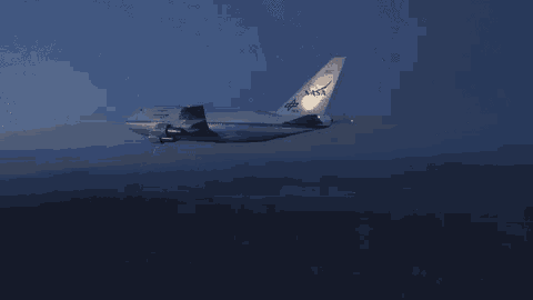 a nasa airplane is flying in the dark